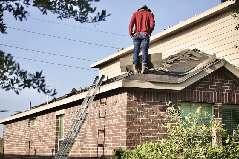 Professional roofer working on a residential roof in Battle Creek West